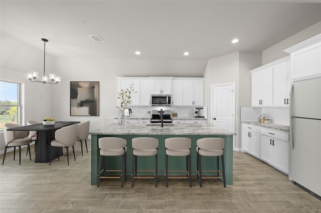 707 Shadle Rd, Poolville, TX 76487 - kitchen with stainless steel appliances, backsplash, an island with sink, recessed lighting, and a chandelier