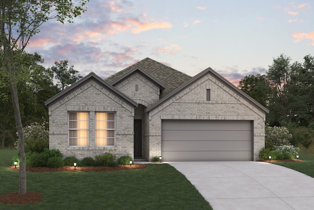 view of front facade with a yard and a garage