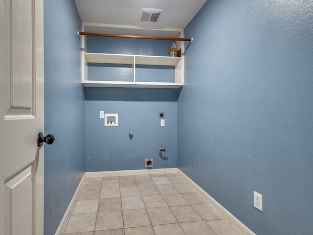 washroom with hookup for an electric dryer, hookup for a gas dryer, light tile patterned floors, and hookup for a washing machine