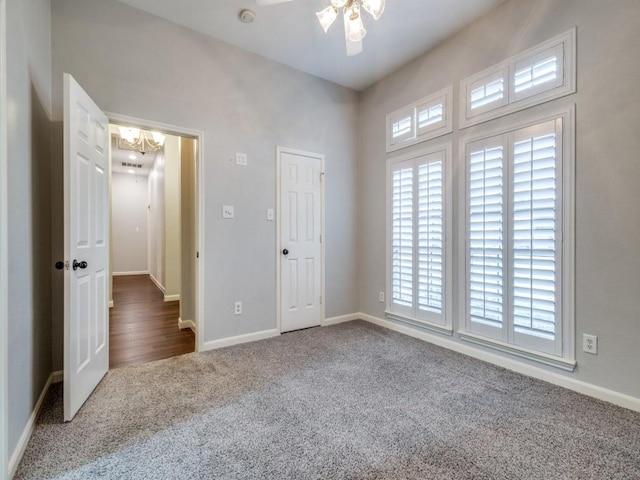 unfurnished bedroom with dark colored carpet