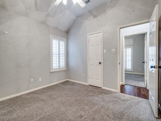 carpeted spare room with ceiling fan and lofted ceiling