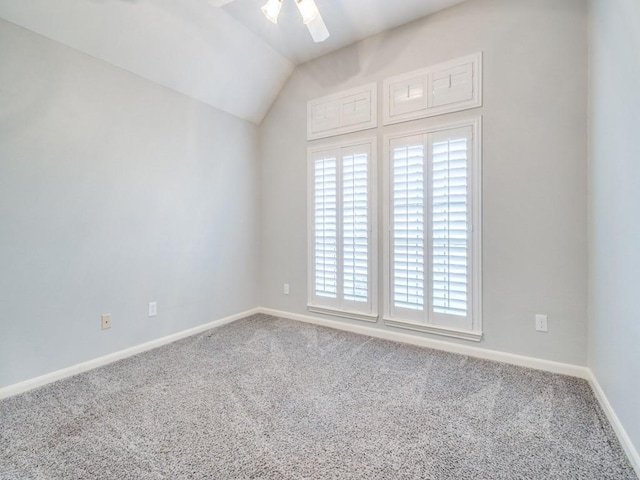 carpeted empty room featuring ceiling fan and lofted ceiling