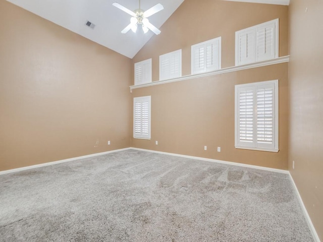 carpeted spare room featuring ceiling fan and high vaulted ceiling