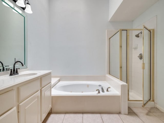 bathroom featuring tile patterned flooring, vanity, and separate shower and tub