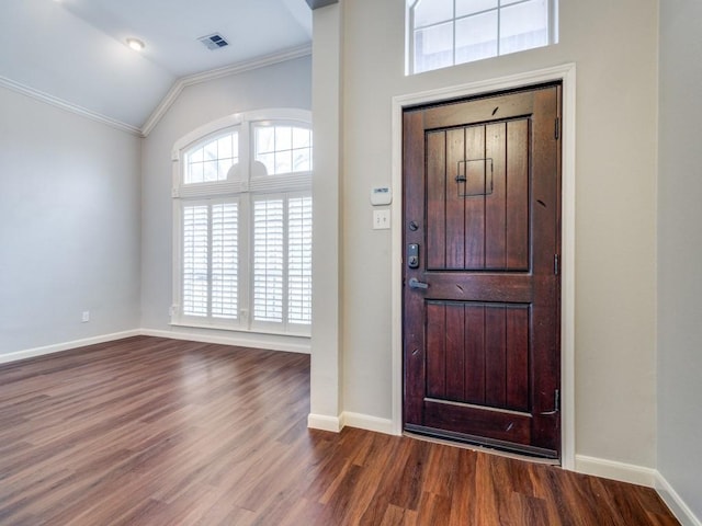 entryway with hardwood / wood-style floors, crown molding, and lofted ceiling