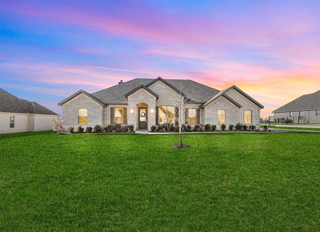 french provincial home with a yard