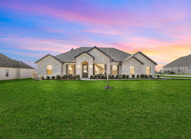 french provincial home with a yard