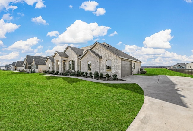 french provincial home with a front yard and a garage