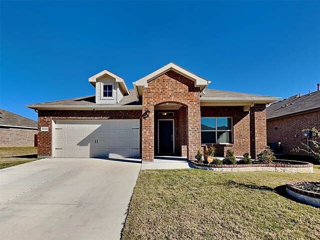 view of front of property with a garage and a front lawn