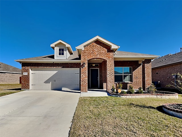 view of front of home featuring a garage and a front lawn