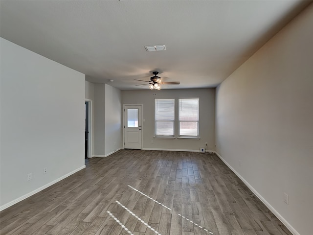 unfurnished living room featuring ceiling fan and light wood-type flooring