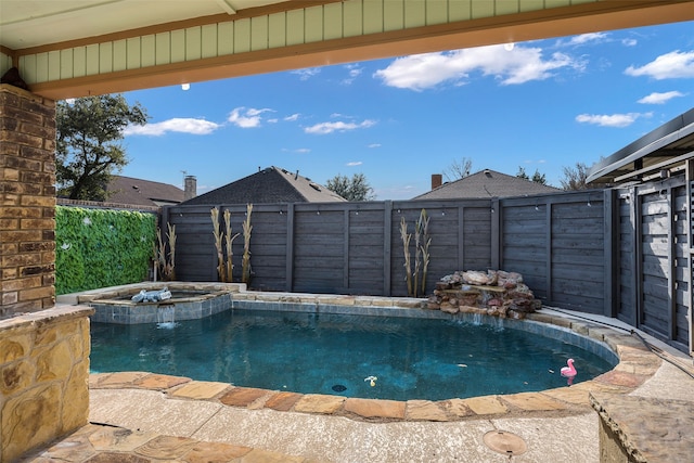 view of swimming pool featuring pool water feature and an in ground hot tub