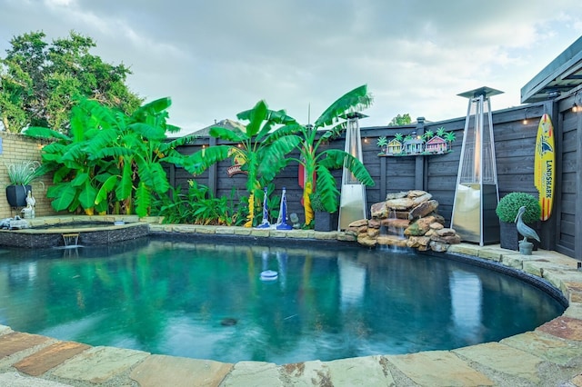 view of swimming pool featuring a fenced backyard