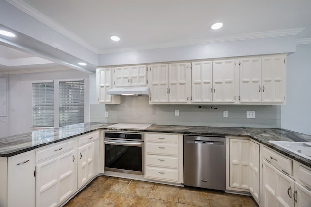 kitchen featuring ornamental molding, appliances with stainless steel finishes, kitchen peninsula, and white cabinets