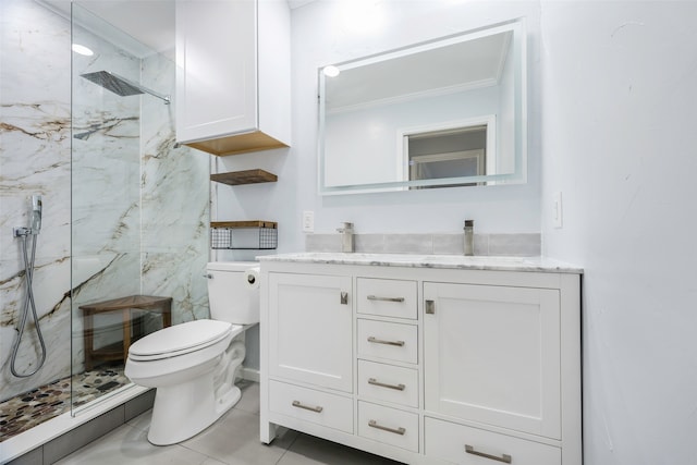 bathroom featuring vanity, a tile shower, crown molding, and toilet