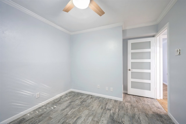 unfurnished room with crown molding, ceiling fan, and wood-type flooring