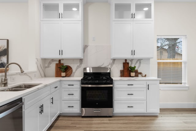 kitchen with white cabinetry, sink, and appliances with stainless steel finishes