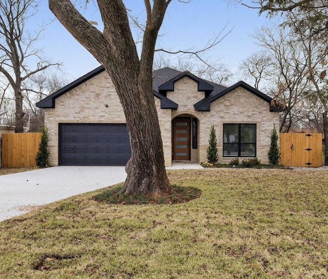 view of front of home with a garage and a front yard