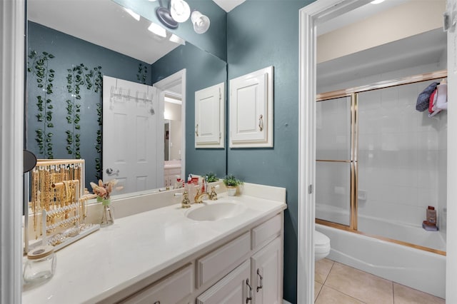 full bathroom featuring tile patterned flooring, vanity, toilet, and combined bath / shower with glass door