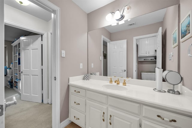 bathroom featuring vanity and toilet