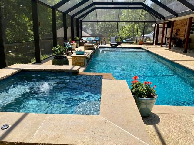 view of swimming pool featuring a lanai and a patio