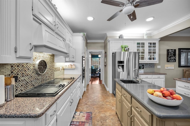 kitchen featuring appliances with stainless steel finishes, white cabinetry, ornamental molding, and sink