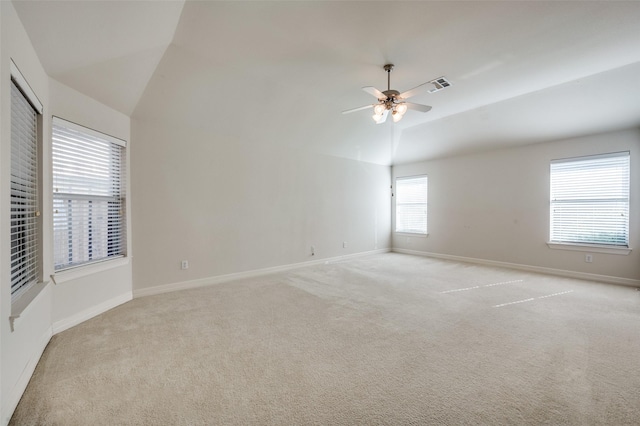 spare room with ceiling fan, light carpet, and lofted ceiling