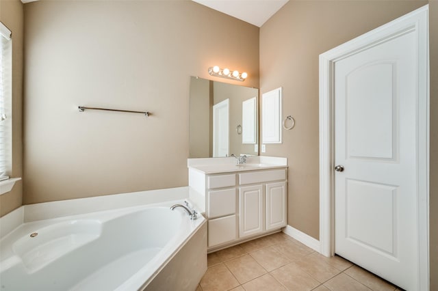 bathroom with vanity, a washtub, and tile patterned flooring