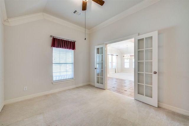 spare room with crown molding, french doors, carpet, vaulted ceiling, and ceiling fan with notable chandelier