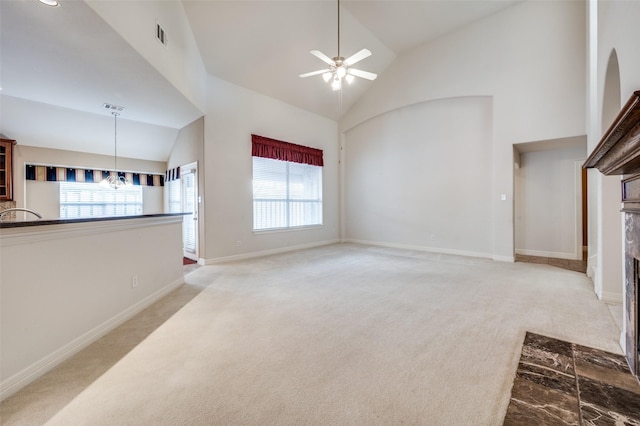 carpeted living room with high vaulted ceiling and ceiling fan