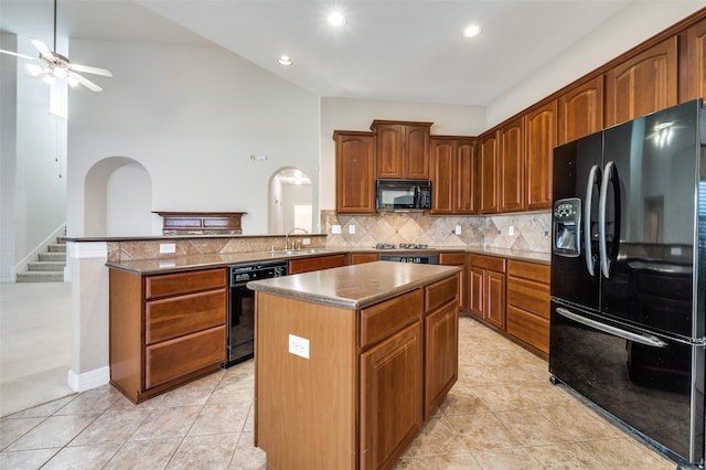 kitchen featuring black appliances, a kitchen island, decorative backsplash, sink, and kitchen peninsula