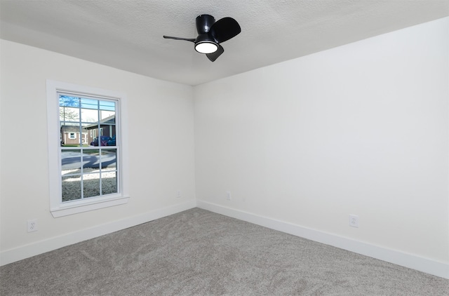 carpeted empty room featuring a textured ceiling and ceiling fan