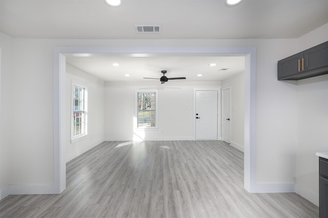 unfurnished living room featuring light wood-type flooring and ceiling fan