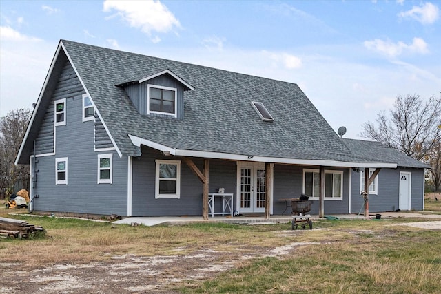 back of house featuring a yard, a patio, and french doors