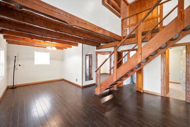 basement featuring dark wood-type flooring and a notable chandelier