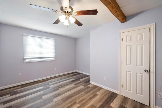 unfurnished room featuring dark hardwood / wood-style flooring, ceiling fan, and beam ceiling