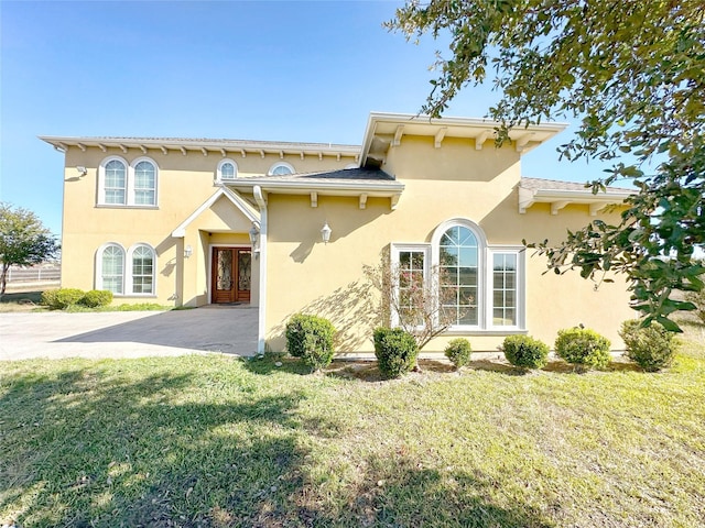 view of front of home featuring french doors and a front lawn