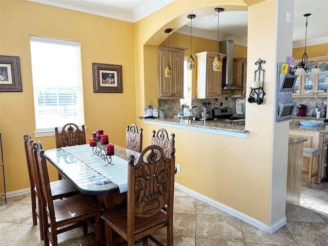 dining area with light tile patterned floors and crown molding