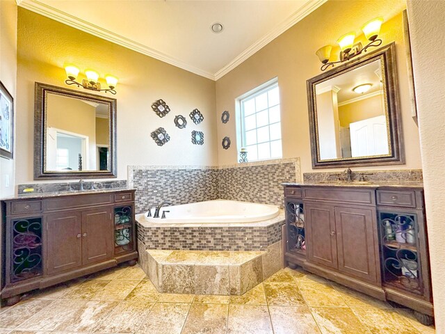 bathroom featuring vanity, ornamental molding, and tiled bath