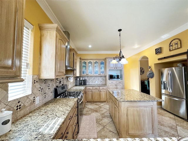 kitchen featuring a center island, wall chimney exhaust hood, decorative backsplash, light stone countertops, and stainless steel appliances