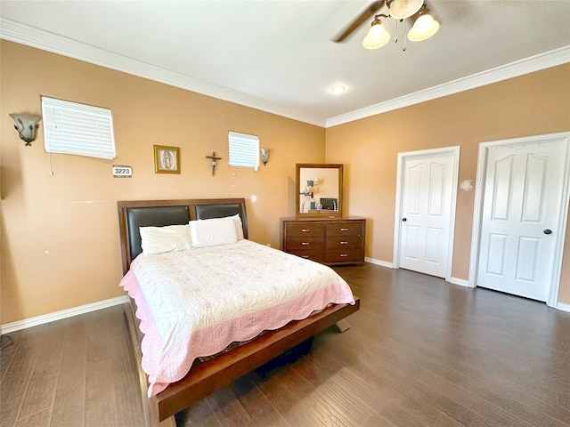 bedroom featuring dark hardwood / wood-style flooring, ceiling fan, and ornamental molding