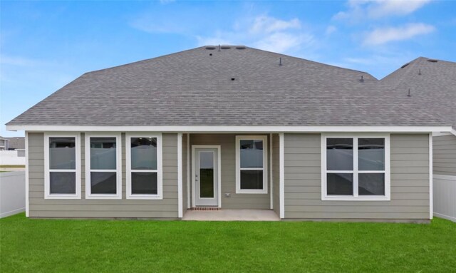 back of property with a lawn and a patio area