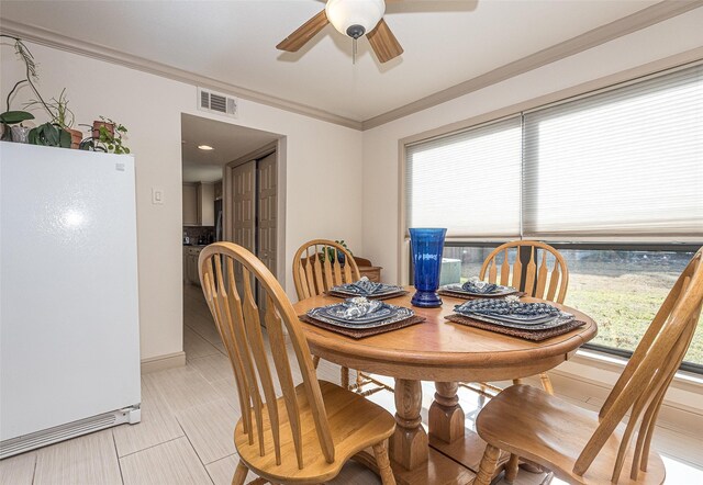 dining room featuring ceiling fan and crown molding