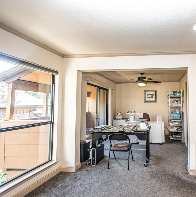 home office featuring ceiling fan, dark carpet, and ornamental molding