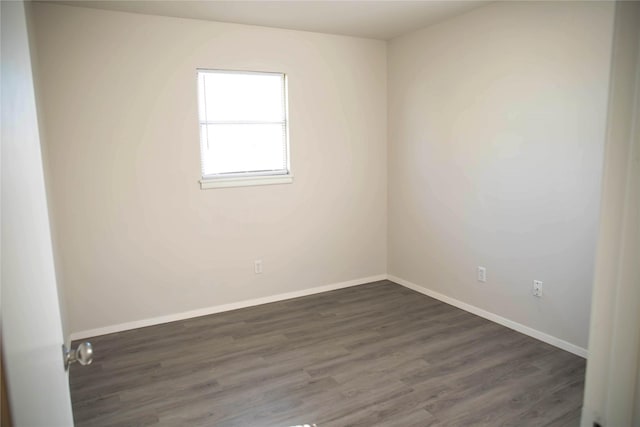 empty room featuring dark hardwood / wood-style flooring