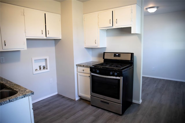 kitchen featuring white cabinetry, dark hardwood / wood-style floors, dark stone countertops, and stainless steel gas range