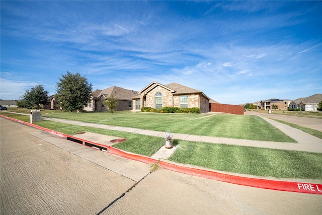 ranch-style home with a front yard