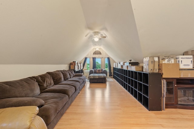 living room with ceiling fan, lofted ceiling, and light hardwood / wood-style flooring