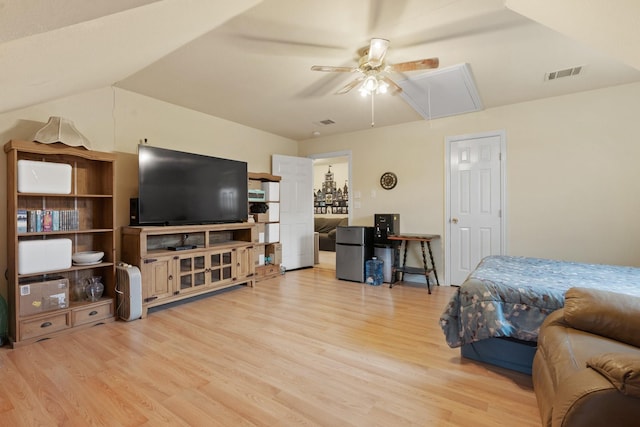 bedroom featuring stainless steel fridge, ceiling fan, and light hardwood / wood-style floors