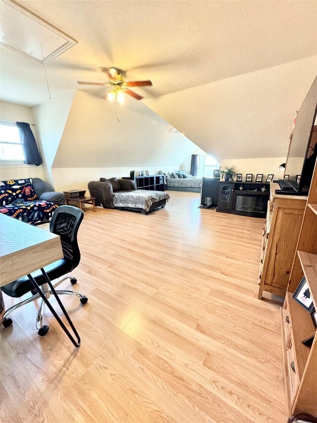 bedroom featuring ceiling fan, light hardwood / wood-style floors, and multiple windows